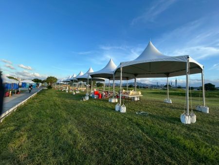 Hexagonal Tents Along the Riverside Lawn